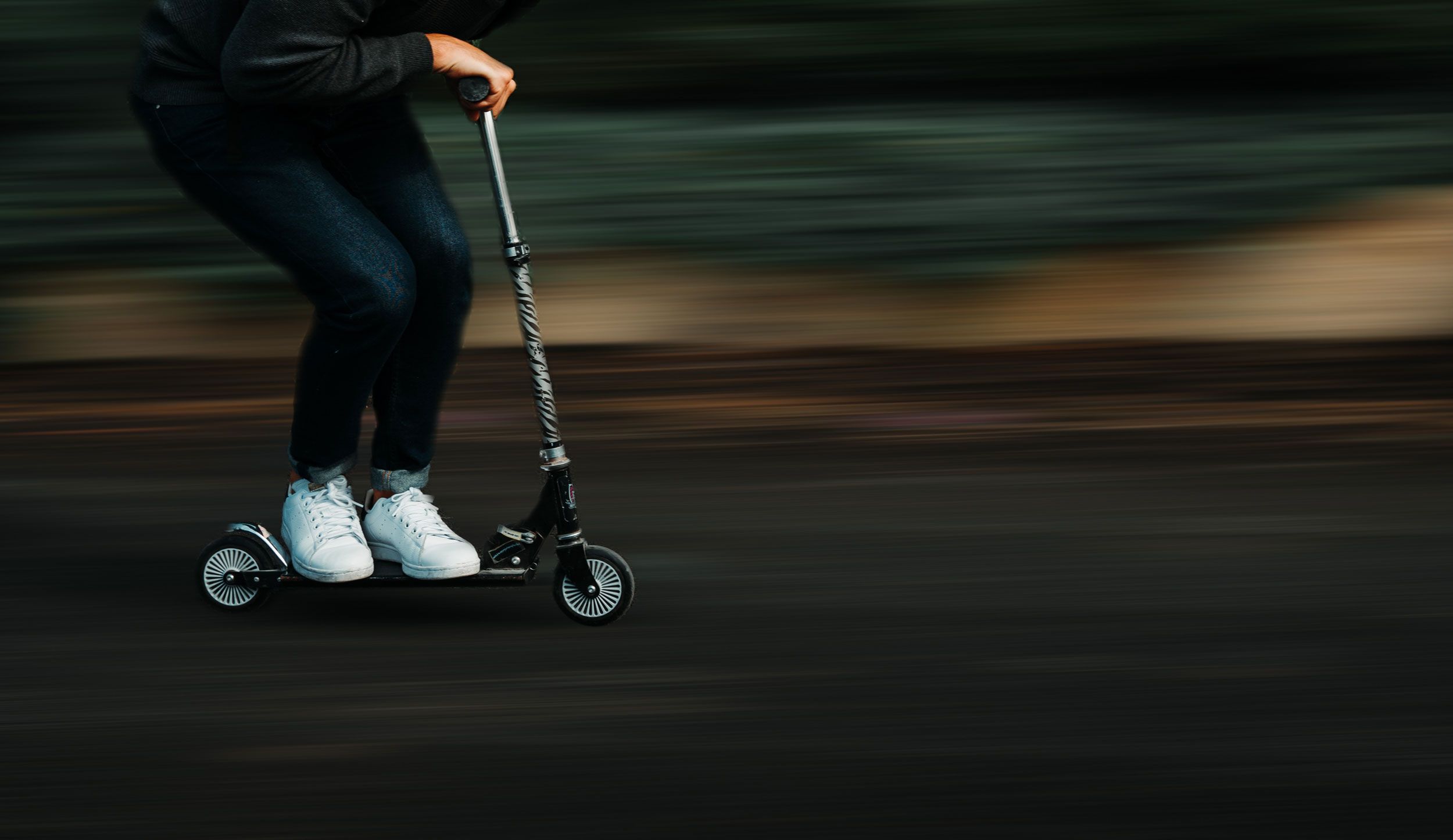 man riding a scooter